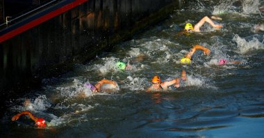 Athletes in action as they swim in the river Seine during the Paris 2024 Olympics, triathlon mixed relay, Paris, France, Aug. 5, 2024. (Reuters Photo) 