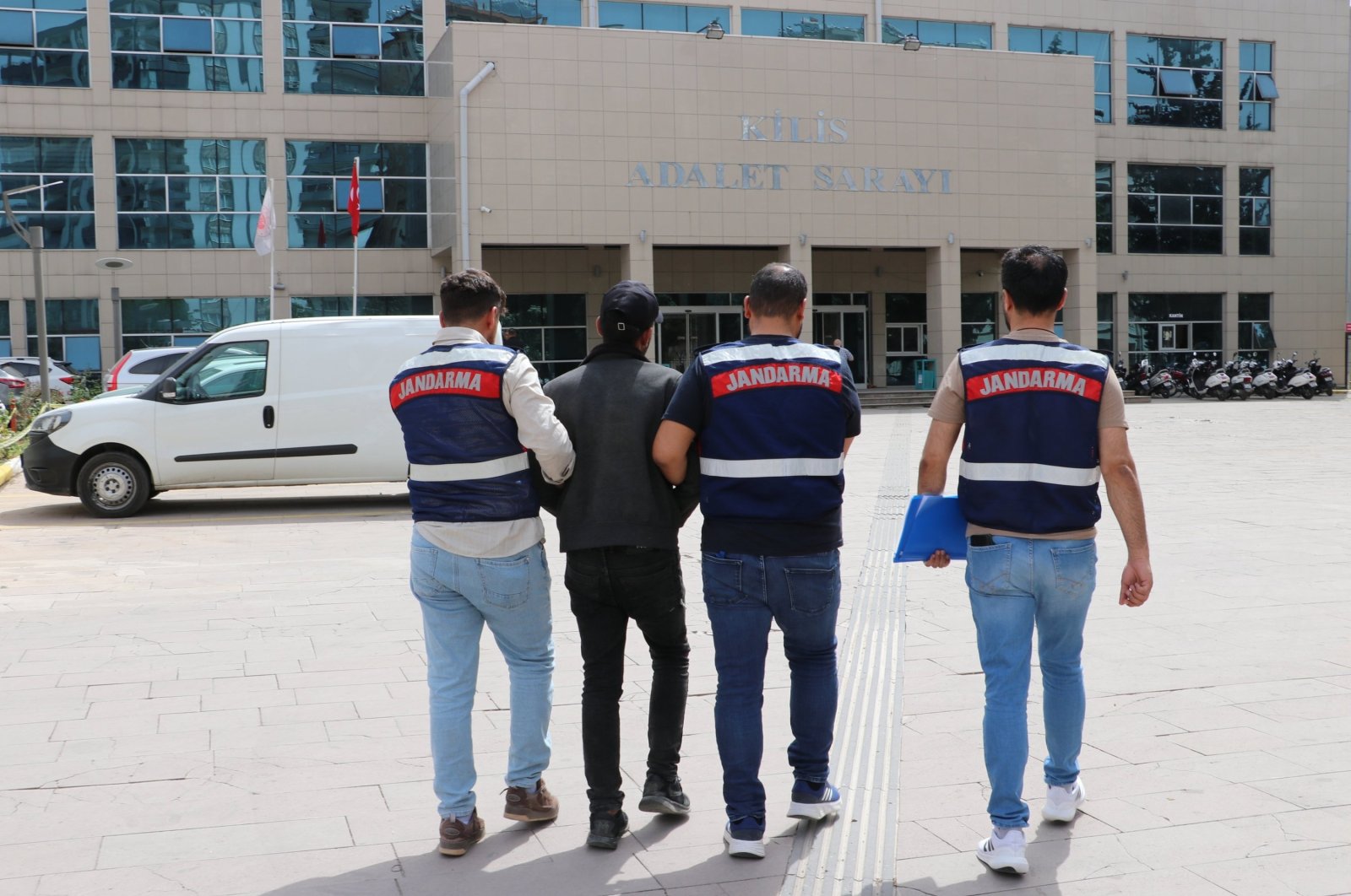 Gendarmerie officers accompany a caught PKK suspect in Kilis, southeastern Türkiye, April 27, 2024. (AA Photo)