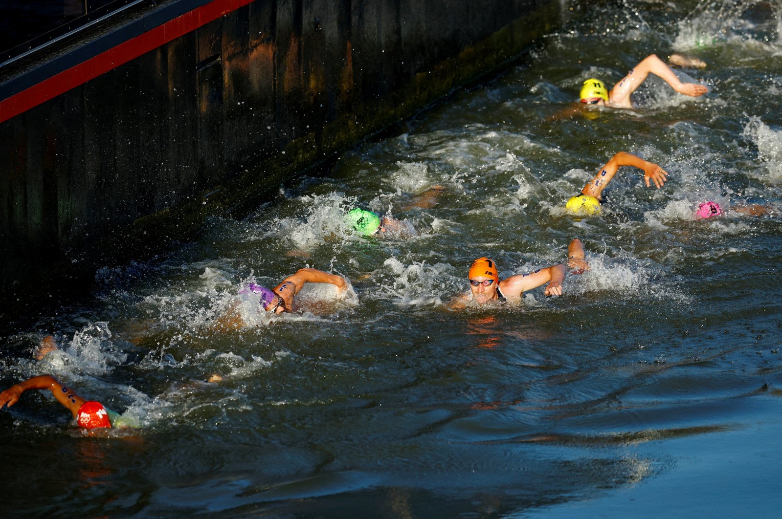 Athletes in action as they swim in the river Seine during the Paris 2024 Olympics, triathlon mixed relay, Paris, France, Aug. 5, 2024. (Reuters Photo) 