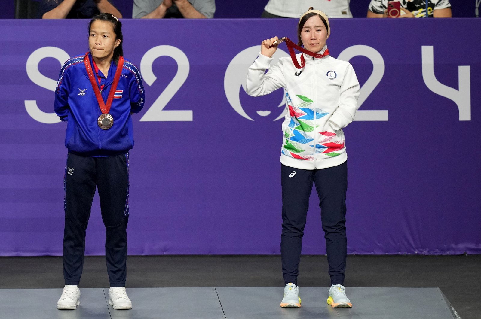 Zakia Khudadadi of the Refugee Paralympic Team (R) celebrates on the podium during the medal ceremony at the Paris 2024 Paralympics, Grand Palais, Paris, France, Aug. 29, 2024. (Reuters Photo)