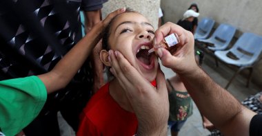 A Palestinian girl is vaccinated against polio, at a U.N. health care center in Deir Al-Balah, in the central Gaza Strip, Palestine, Sept. 1, 2024. (Reuters Photo) 