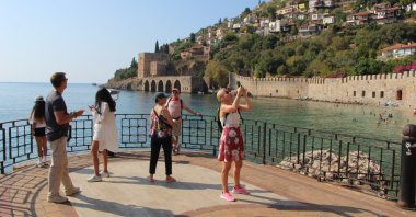 Tourists are photographed in the Alanya district of Antalya, southern Türkiye, Aug, 26, 2024. (AA Photo)