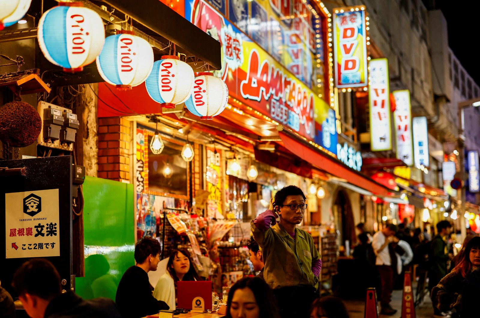 People enjoy drinks and food at izakaya pub restaurants at the Ameyoko shopping district, Tokyo, Japan, Feb. 15, 2024. (Reuters Photo)