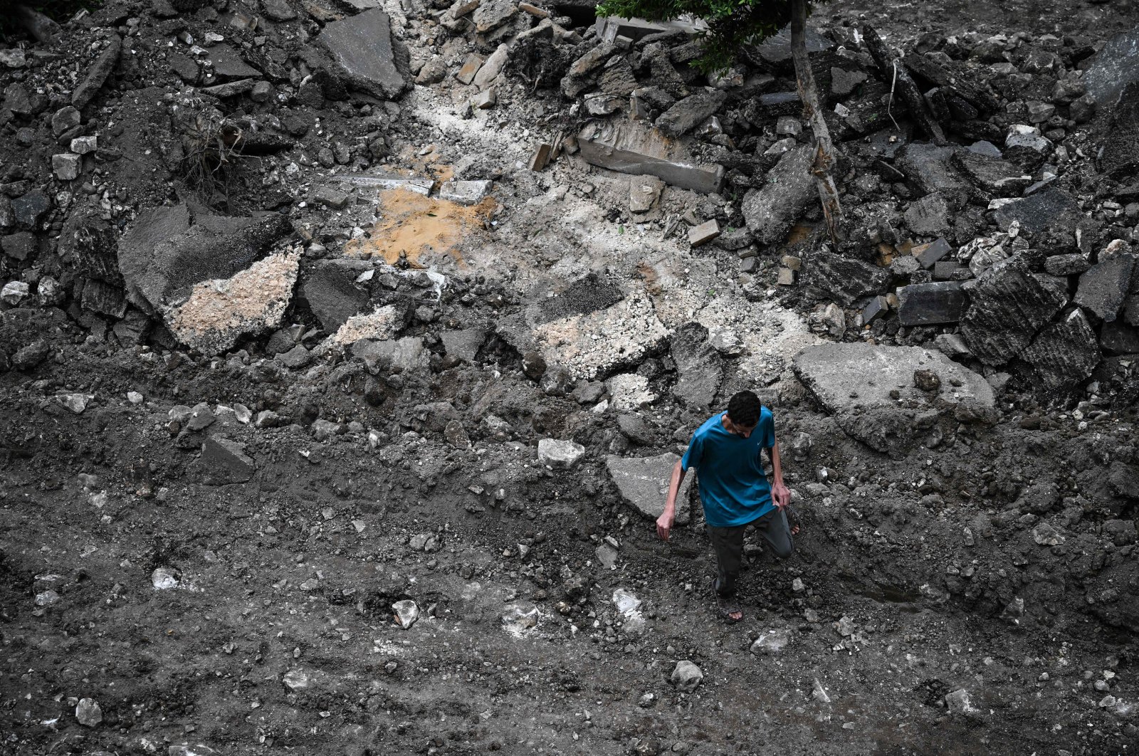 A Palestinian man walks on a street torn up by bulldozers during an Israeli raid in the occupied West Bank city of Jenin, Palestine, Sept. 1, 2024. (AFP Photo)