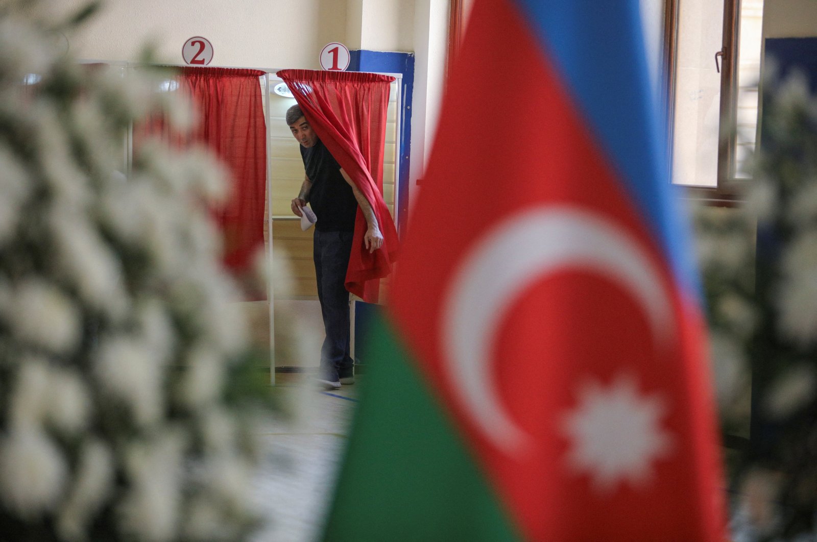 A man walks out of a voting booth at a polling station during parliamentary elections in Baku, Azerbaijan September 1, 2024. (Reuters Photo)