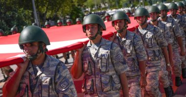 Turkish soldiers march with a Turkish flag during the military parade on Victory Day, an official and national holiday celebrated every year in Türkiye to commemorate the Great Offensive, which ended in victory under Atatürk&#039;s command in Dumlupınar, Ankara, Türkiye, Aug. 30, 2024. (Reuters Photo)