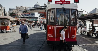 People pass by a tram on the famous Istiklal Street, Istanbul, Türkiye, June 5, 2024. (Reuters Photo)