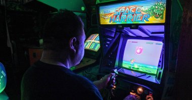 Vintage video game collector &quot;Proudro&quot; plays a vintage video game at his home in Kasumigaura, Ibaraki prefecture, Japan, June 24, 2024. (AFP Photo)