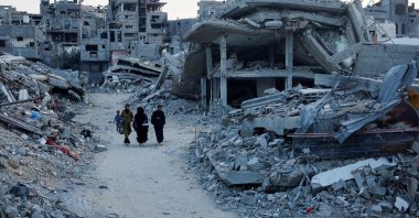 Palestinians walk amidst the rubble of buildings destroyed after an Israeli strike, amid the ongoing conflict between Israel and Hamas, in Khan Younis, in the southern Gaza Strip Sept. 1, 2024. (Reuters Photo)