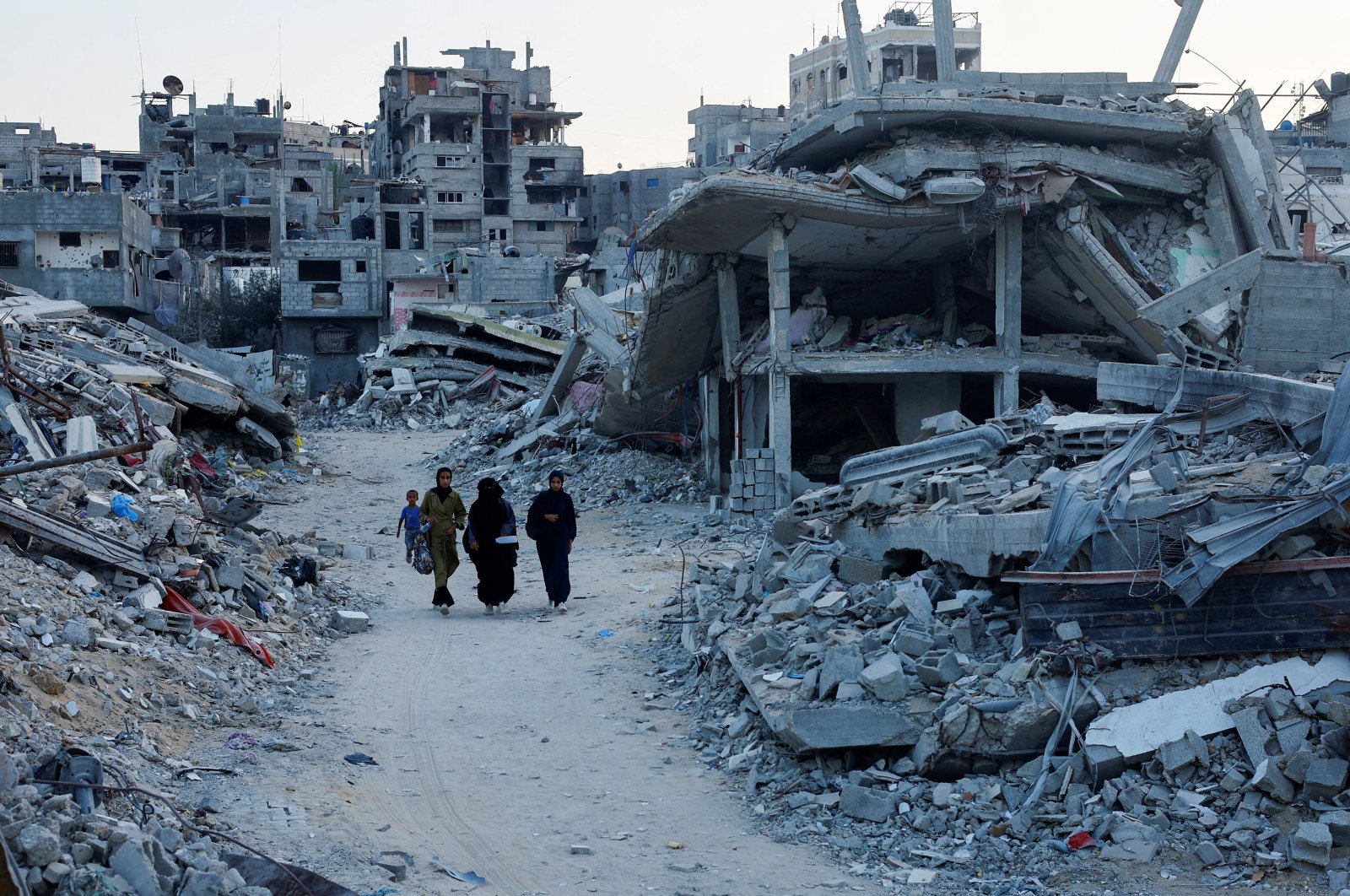 Palestinians walk amidst the rubble of buildings destroyed after an Israeli strike, amid the ongoing conflict between Israel and Hamas, in Khan Younis, in the southern Gaza Strip Sept. 1, 2024. (Reuters Photo)