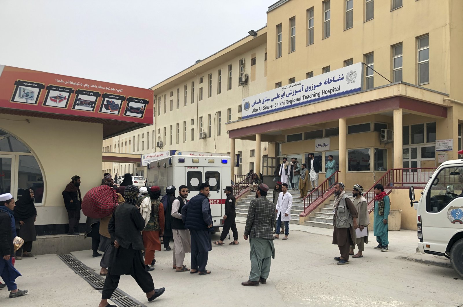 People stand outside a hospital after a bomb blast in Mazar-e Sharif, the capital city of Balkh province, in northern Afghanistan, Thursday, March 9, 2023. (AP File Photo)