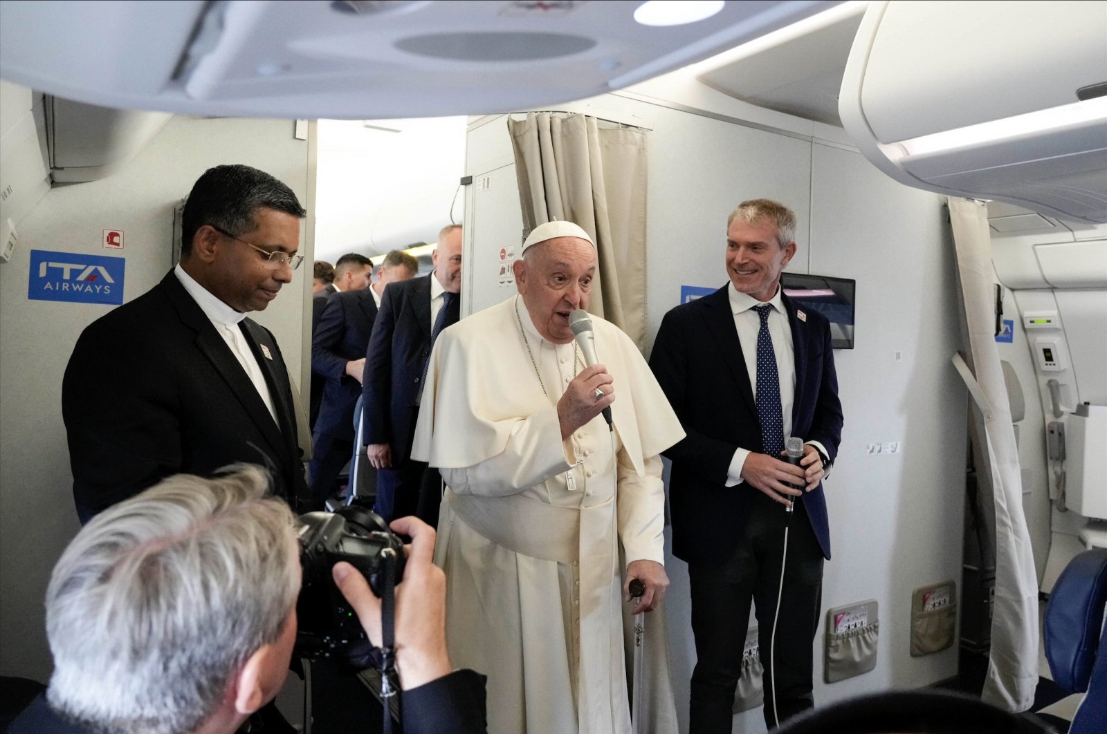 Pope Francis (Center), flanked by his spokesperson Matteo Bruni (Right), talks to journalists aboard the flight bound for Jakarta, the first stop of his Apostolic Journey to Southeast Asia, Sept. 2, 2024. (EPA Photo)