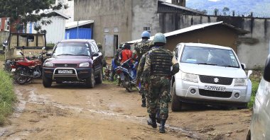 This file photo shows U.N. peacekeepers soldiers patrolling the entrance of a prison in Beni, Congo, Oct. 20. 2020. (AP Photo)