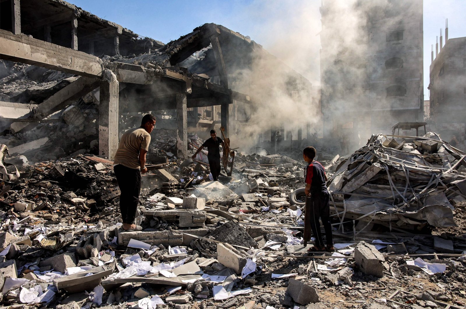 Men walk through debris in a building that was hit by Israeli bombardment in the Sheikh Radwan neighborhood in the north of Gaza City, Sept. 3, 2024. (AFP Photo)