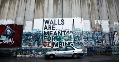 A car is parked next to the Israeli wall in Bethlehem, in the Israeli-occupied West Bank, Palestine, Dec. 24, 2023. (Reuters Photo)