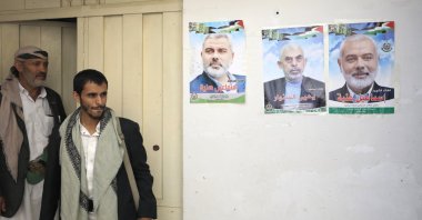 Two Yemeni men are seen near posters of late Hamas leader Ismail Haniyeh and current chief Yahya Sinwar, in Sana'a, Yemen, Aug. 19, 2024. (EPA Photo)