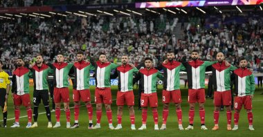 Palestine team players stand for the national anthem ahead of the Asian Cup Group C match between Iran and Palestine at the Education City Stadium, Al Rayyan, Qatar, Jan. 14, 2024. (AP Photo)