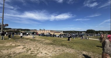  Students are evacuated to the football stadium after the school campus was placed on lockdown at Apalachee High School in Winder, Ga., on Wednesday, Sept. 4, 2024.  (Erin Clark via AP)