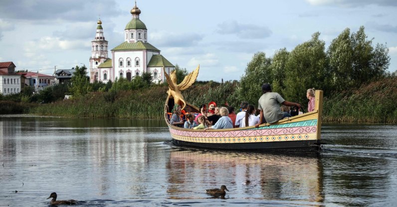 Tourists ride in an ornate wooden boat along the Kamenka River in the town of Suzdal, northeast of Moscow, Russia, Aug. 24, 2024. (AFP Photo)