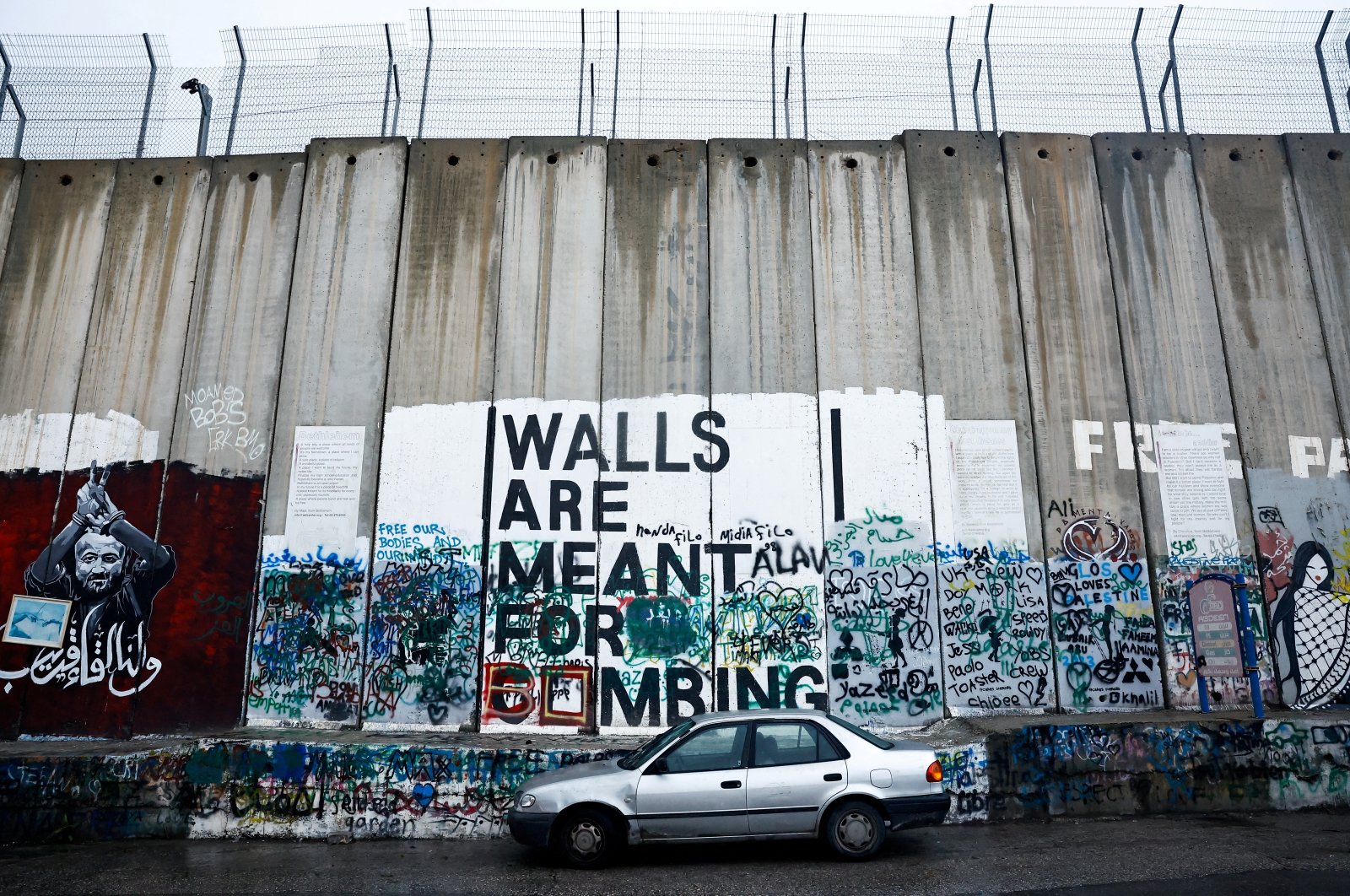 A car is parked next to the Israeli wall in Bethlehem, in the Israeli-occupied West Bank, Palestine, Dec. 24, 2023. (Reuters Photo)