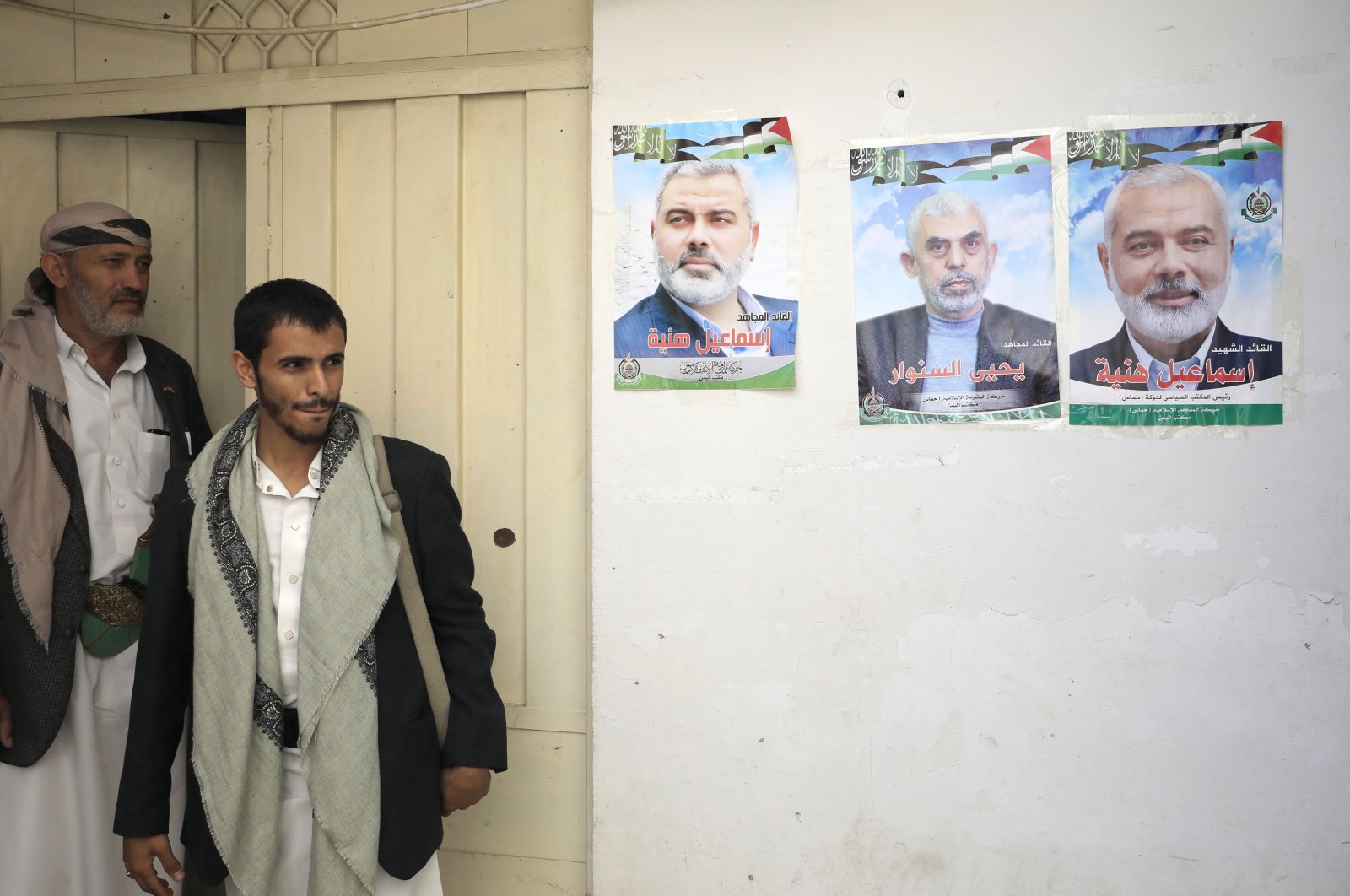 Two Yemeni men are seen near posters of late Hamas leader Ismail Haniyeh and current chief Yahya Sinwar, in Sana&#039;a, Yemen, Aug. 19, 2024. (EPA Photo)