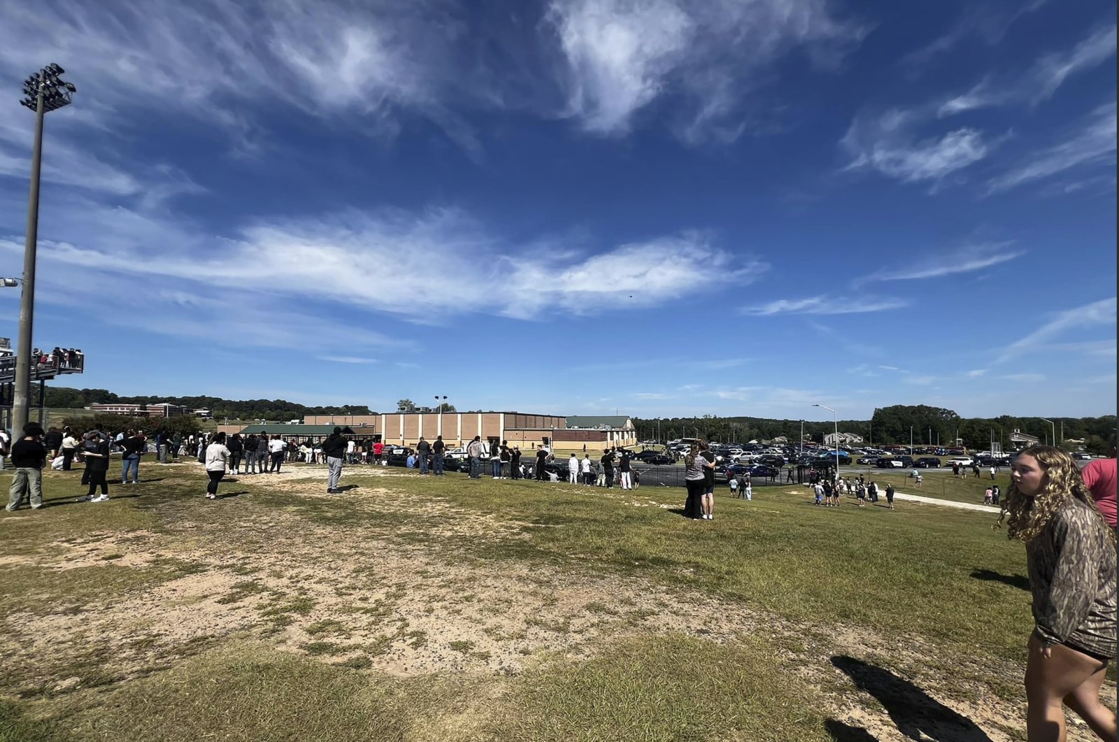  Students are evacuated to the football stadium after the school campus was placed on lockdown at Apalachee High School in Winder, Ga., on Wednesday, Sept. 4, 2024.  (Erin Clark via AP)