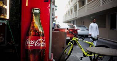 A Coca-Cola refrigerator is seen at a local restaurant as a man passes by, in downtown Manama, Bahrain, Aug. 31, 2024. (Reuters Photo)