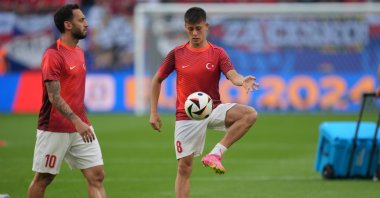 Hakan Çalhanoğlu (L) and Arda Güler of Türkiye warm up before the match with Czhechia during the UEFA European Football Championship in Hamburg, Germany, June 26, 2024. (Getty Images Photo)