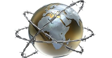 Globe shows Europe and Africa wrapped with barbwire. (Getty Images Photo)