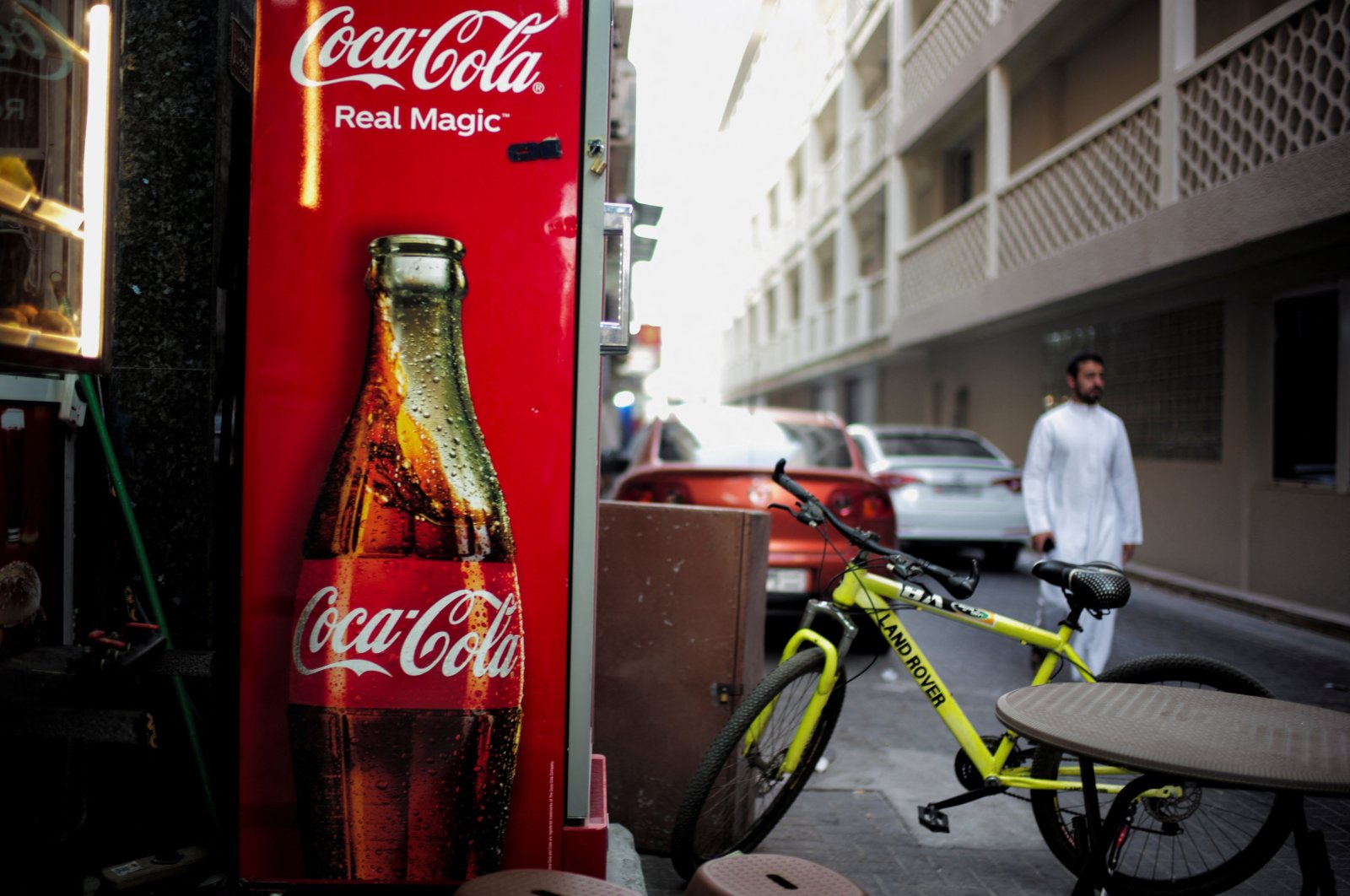 A Coca-Cola refrigerator is seen at a local restaurant as a man passes by, in downtown Manama, Bahrain, Aug. 31, 2024. (Reuters Photo)