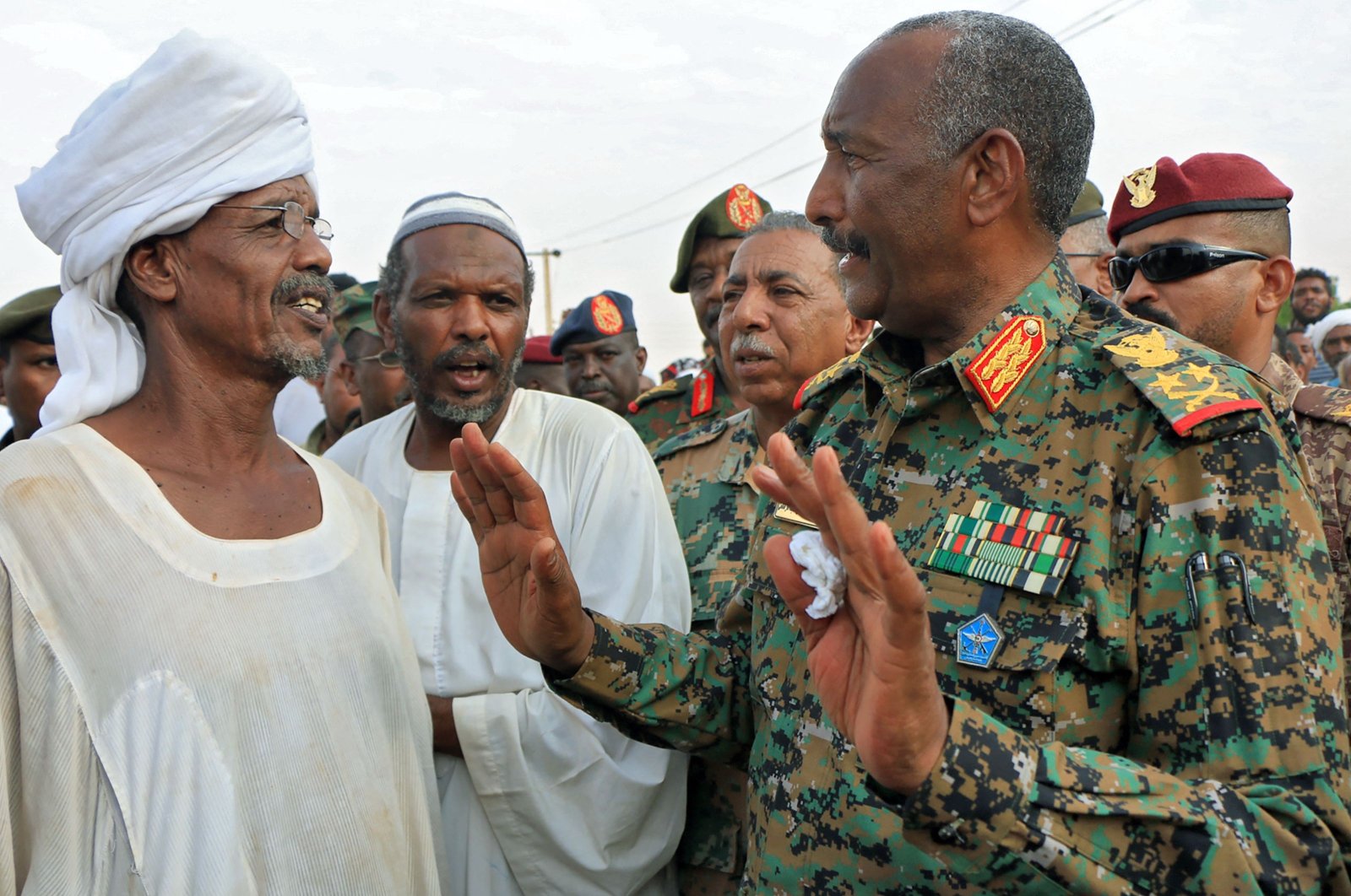 Army chief Abdel-Fattah al-Burhan talks to locals as he arrives in Messawi near Meroe in Northern State in the aftermath of flooding, Sudan, Aug. 29, 2024. (AFP Photo)