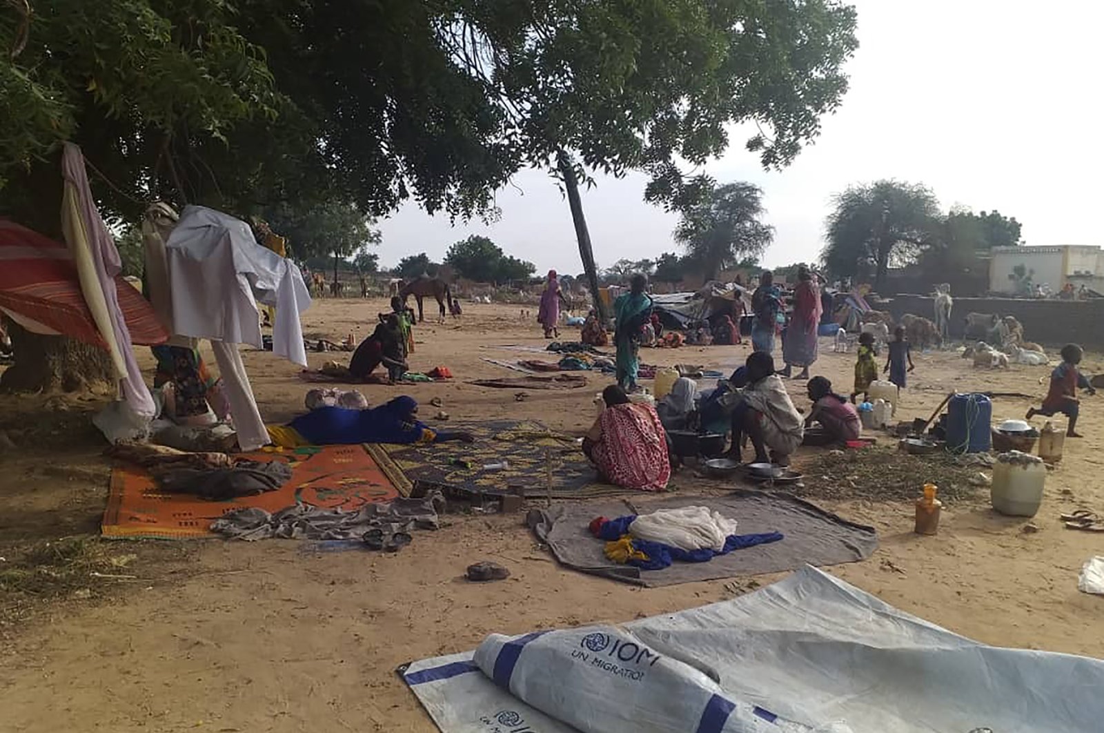 Residents displaced from a surge of violent attacks squat on blankets and in hastily made tents in the village of Masteri, west Darfur, Sudan, July 30, 2020. (AP Photo)