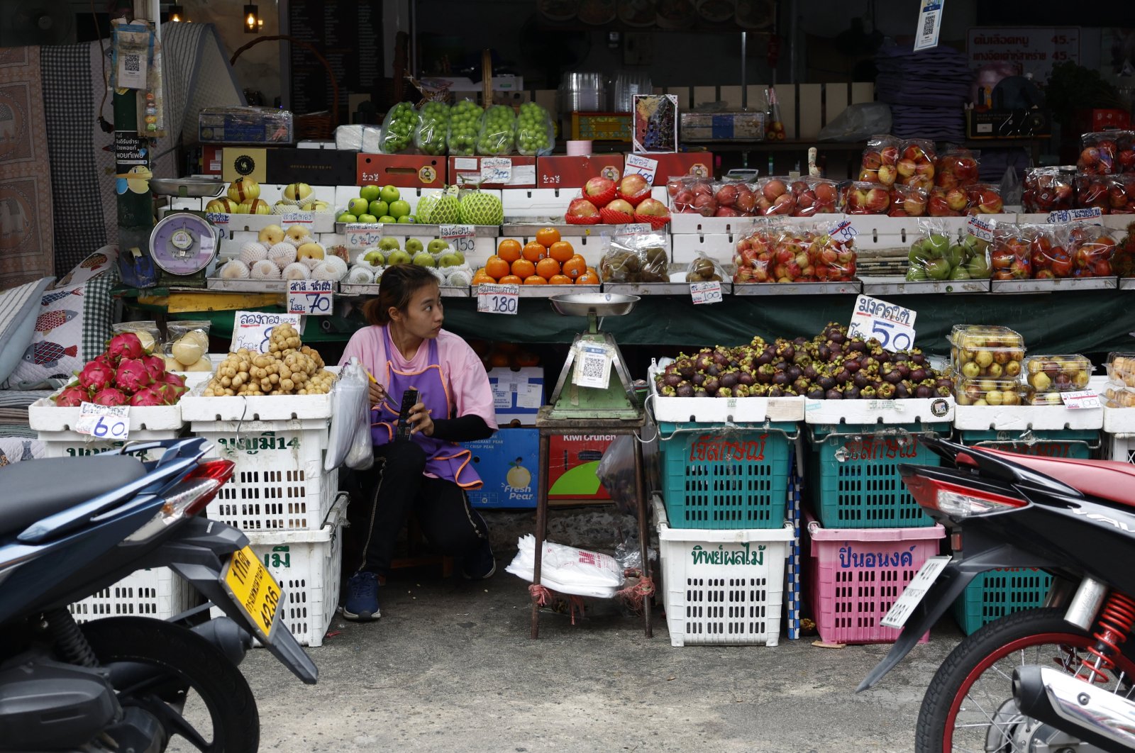 A fruit vendor waits for customers at her shop in a market in Bangkok, Thailand, Sept. 3, 2024. (EPA Photo)