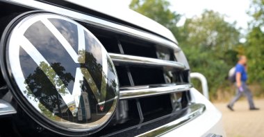 A person walks near a Volkswagen vehicle, ahead of a Volkswagen&#039;s works council regular meeting with workers in Wolfsburg, Germany, Sept. 3, 2024. (Reuters Photo)