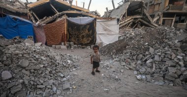 An internally displaced Palestinian child who fled with his family from the northern Gaza Strip stands outside their shelter in Khan Younis, southern Gaza Strip, Palestine, Sept. 7, 2024. (EPA Photo)