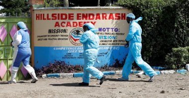 Government pathologists outside the Hillside Endarasha Academy, after a fatal fire killed and injured several pupils, in Kieni, Nyeri County, Kenya, Sept. 7, 2024. (Reuters Photo)