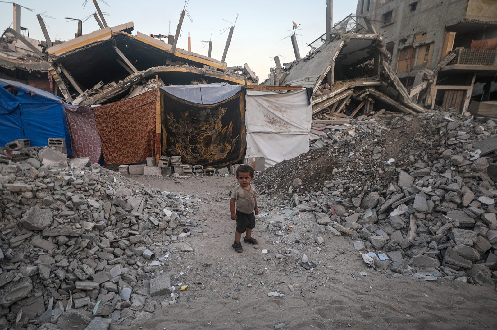 An internally displaced Palestinian child who fled with his family from the northern Gaza Strip stands outside their shelter in Khan Younis, southern Gaza Strip, Palestine, Sept. 7, 2024. (EPA Photo)