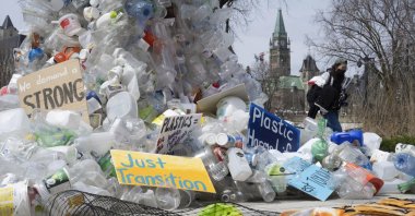 A person walks past an art installation outside a United Nations conference on plastics, Ottawa, Canada, April 23, 2024. (AP Photos)