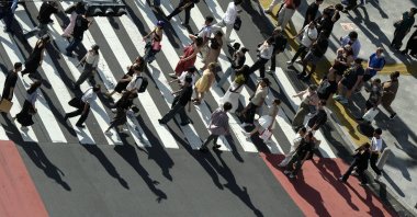 Pedestrians cast shadows on a crosswalk, Tokyo, Japan, Sept. 9, 2024. (EPA Photo)