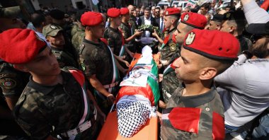 Palestinian security forces carry the body of slain Turkish-American activist Aysenur Ezgi Eygi, covered with a chequered keffiyeh and the Palestinian flag, during a memorial service starting from the Rafidia hospital in Nablus where she was pronounced dead two days earlier, in the occupied West Bank on Sept. 9, 2024. (AFP Photo)