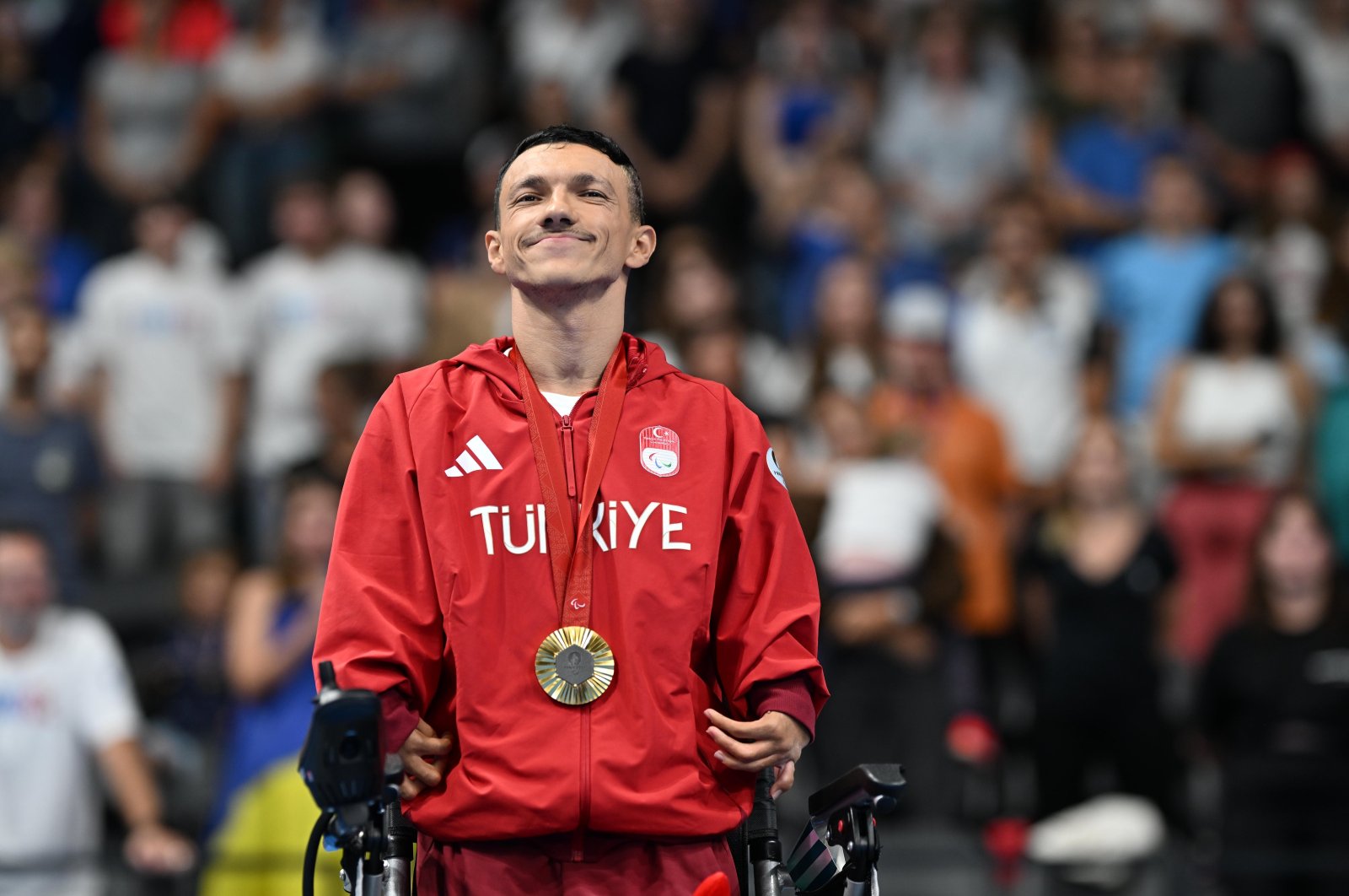 Turkish swimmer Umut Ünlü stands at the podium after winning a gold medal at the 2024 Paris Olympics, Paris, France, Sept. 8, 2024. (AA Photo)