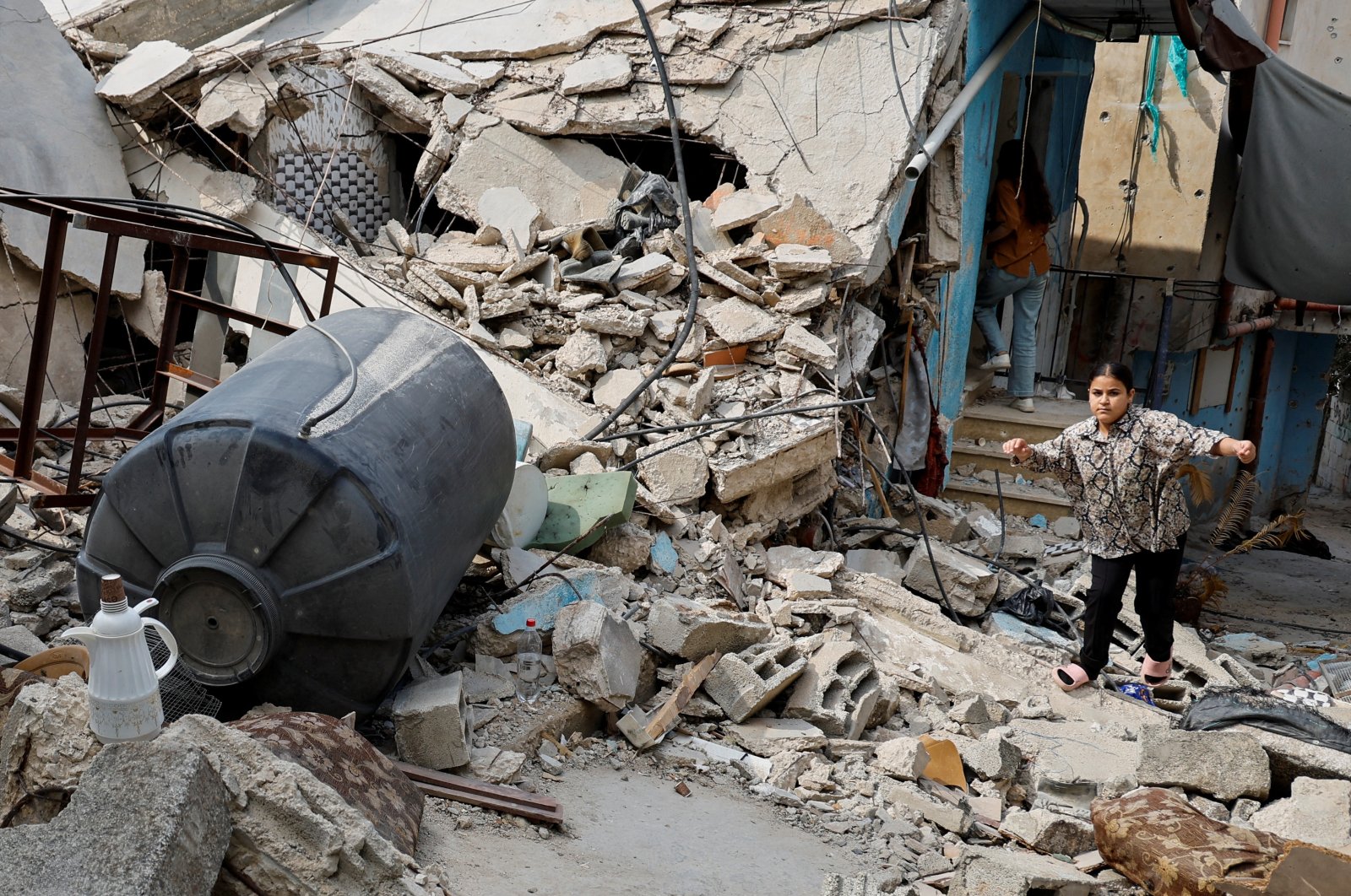 A person tries to walk among debris following several dayslong Israeli raid, in Jenin, in the Israeli-occupied West Bank, Sept. 6, 2024. (Reuters Photo)