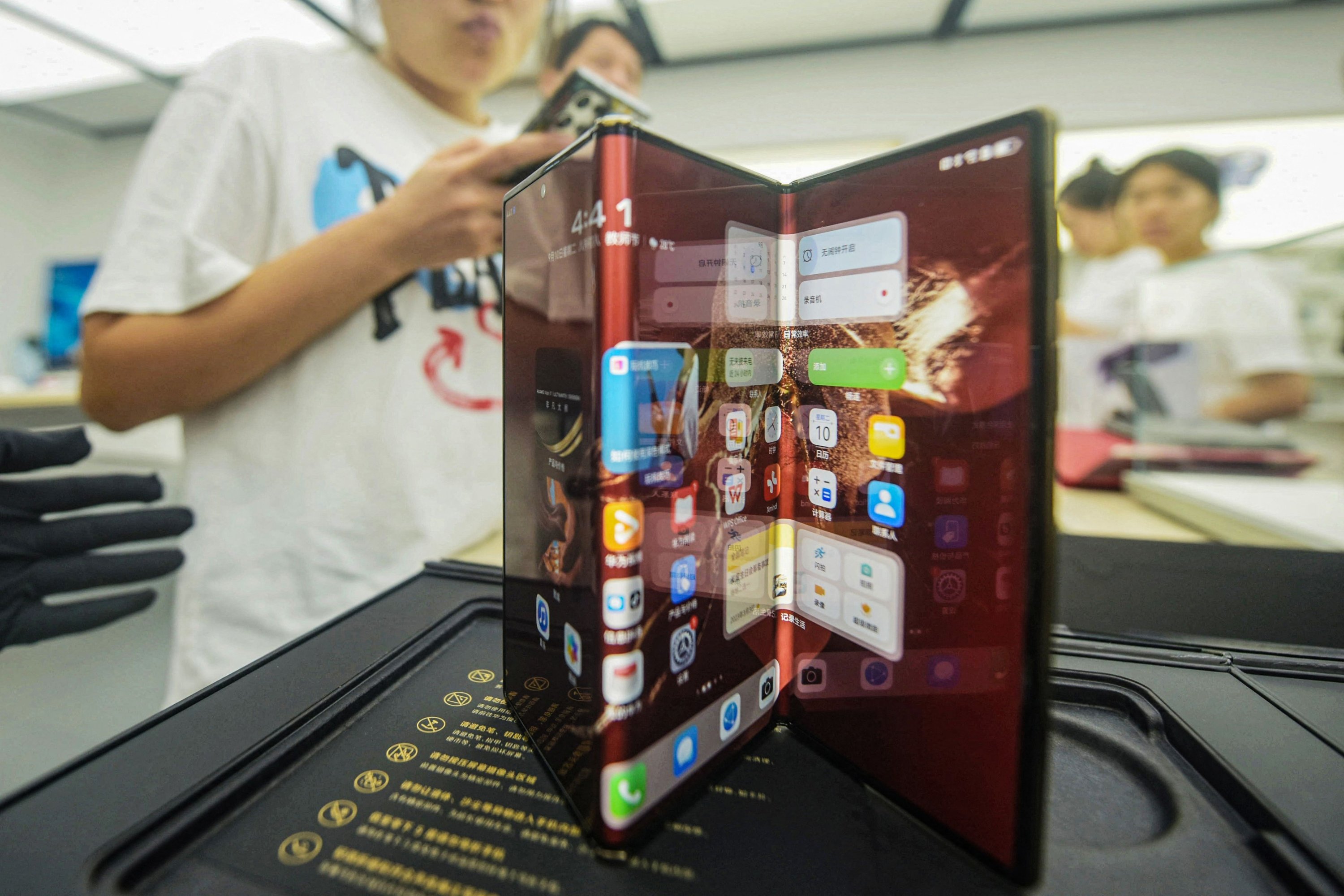 Chinese tech giant Huawei's new trifold phone Huawei Mate XT is displayed during its launch day at a Huawei store in Hangzhou, in eastern Zhejiang province, China, Sept. 10, 2024. (AFP Photo)