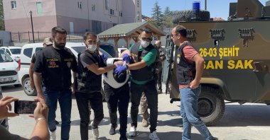 Police officers escort arrested attacker Arda K., Eskişehir, central Türkiye, Aug. 13, 2024. (DHA Photo)