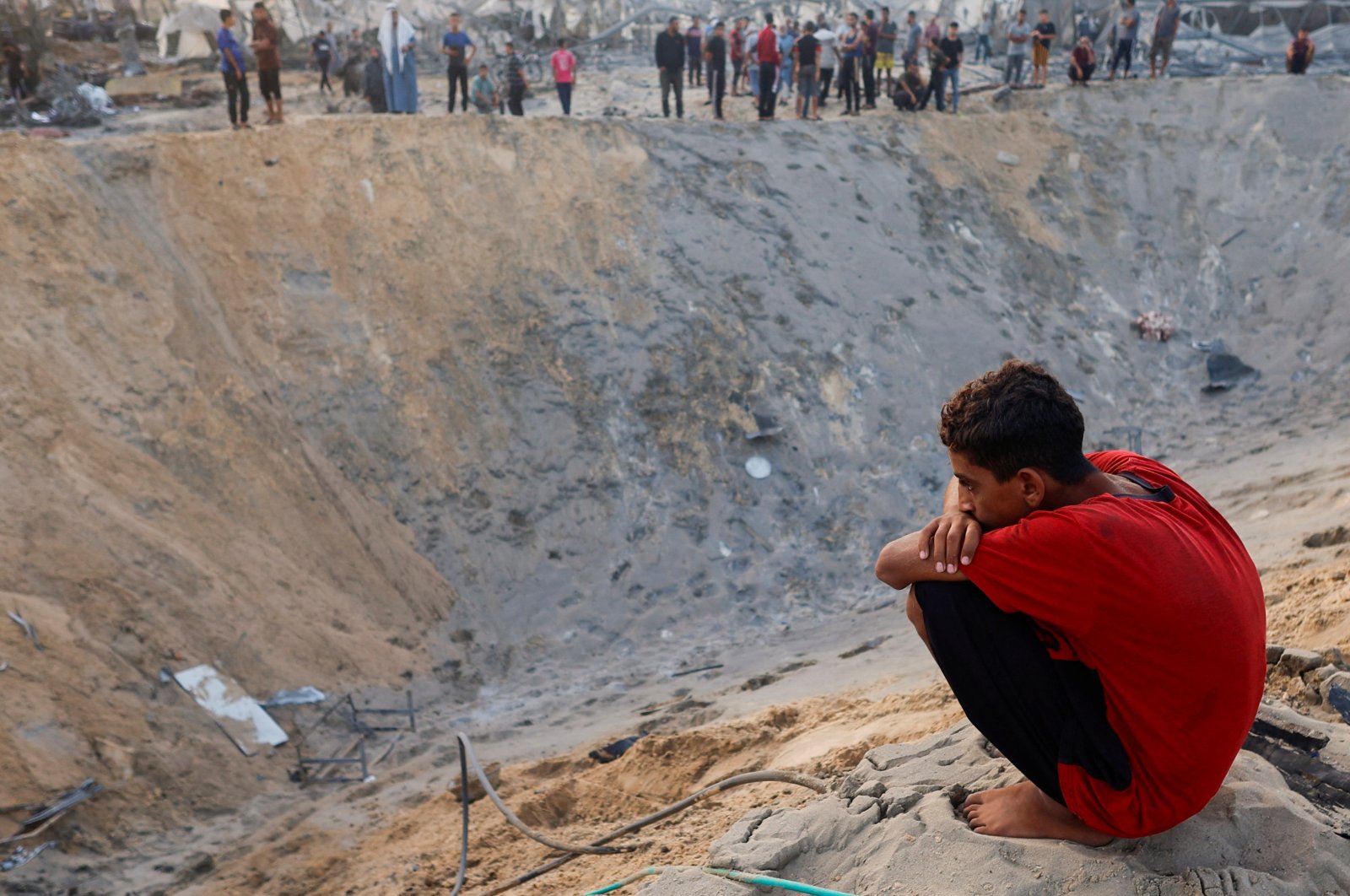 A Palestinian boy looks on at the site following Israeli strikes on a tent camp sheltering displaced people, at the Al-Mawasi area in Khan Younis, in the southern Gaza Strip, Palestine, Sept. 10, 2024. (Reuters Photo)