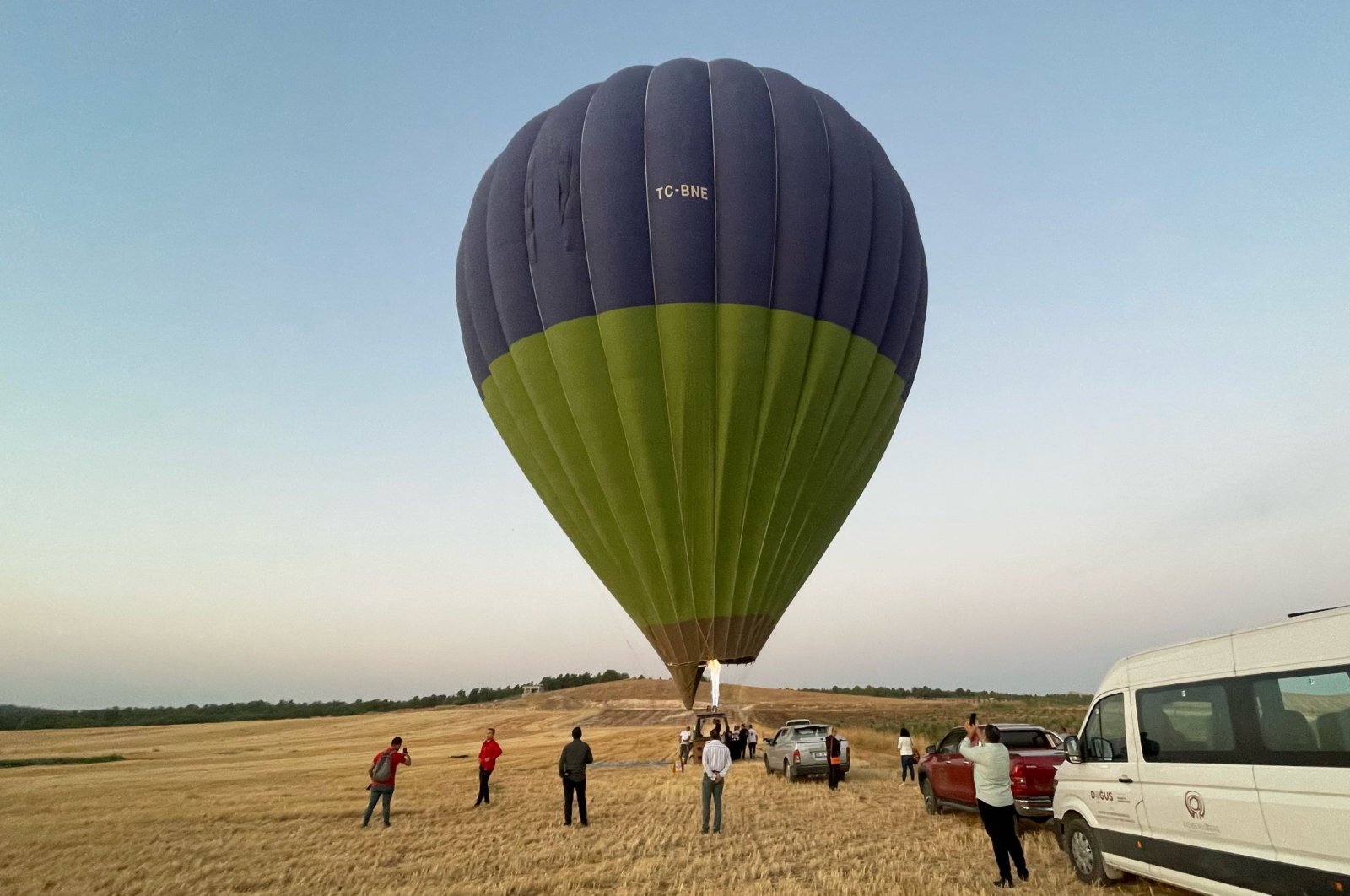 People taking photos of a hot air balloon while others board the balloon for a ride, Göbeklitepe, Şanlıurfa, Türkiye, Sept. 8, 2024. (AA Photo)