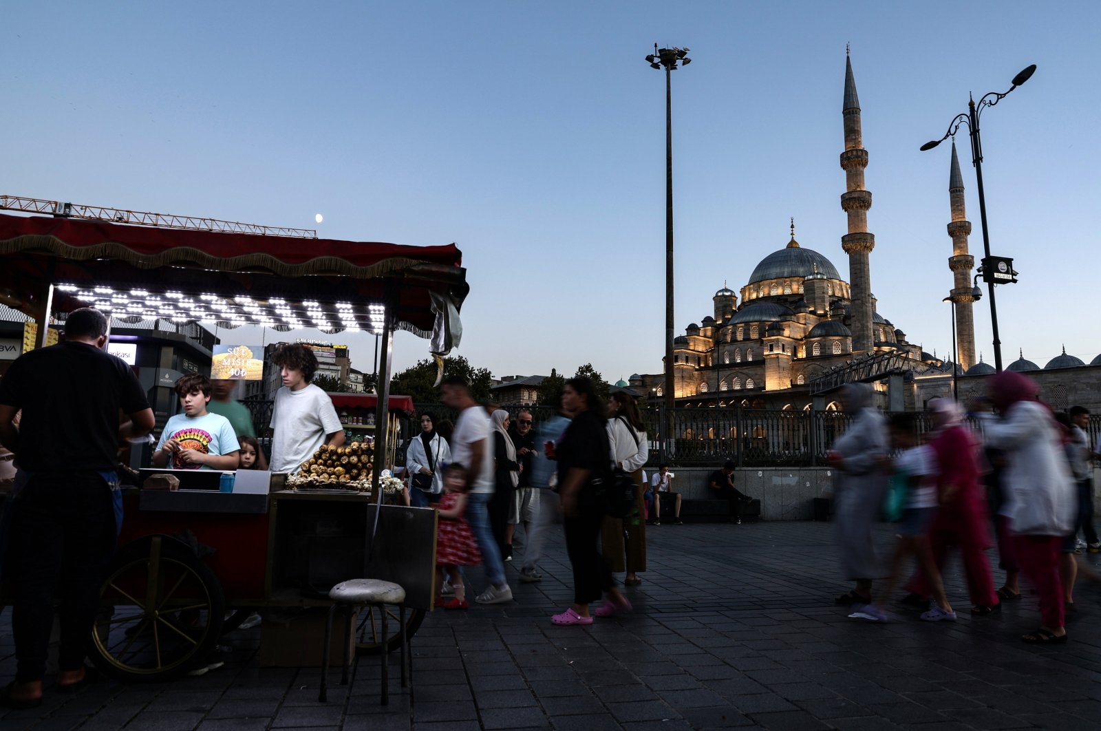 People walk in the famed neighborhood of Eminönü during sunset in Istanbul, Türkiye, Aug. 15, 2024. (EPA Photo)