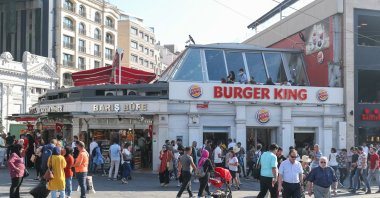 People pass by a branch of the fast-food burger chain Burger King in the area of Taksim Square, Istanbul, Türkiye, Oct. 3, 2019. (Reuters Photo)