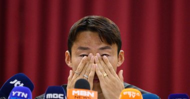 South Korean footballer Son Jun-ho wipes his eyes during a press conference at his K League club Suwon FC, Suwon, South Korea, Sept. 11, 2024. (AFP Photo)