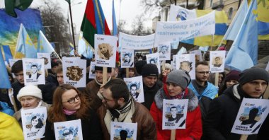 Ukrainian and Crimean Tatar activists hold portraits with the names of victims of the Russian annexation of Crimea during a rally, Kyiv, Ukraine, Feb. 26, 2017. (AP Photo)
